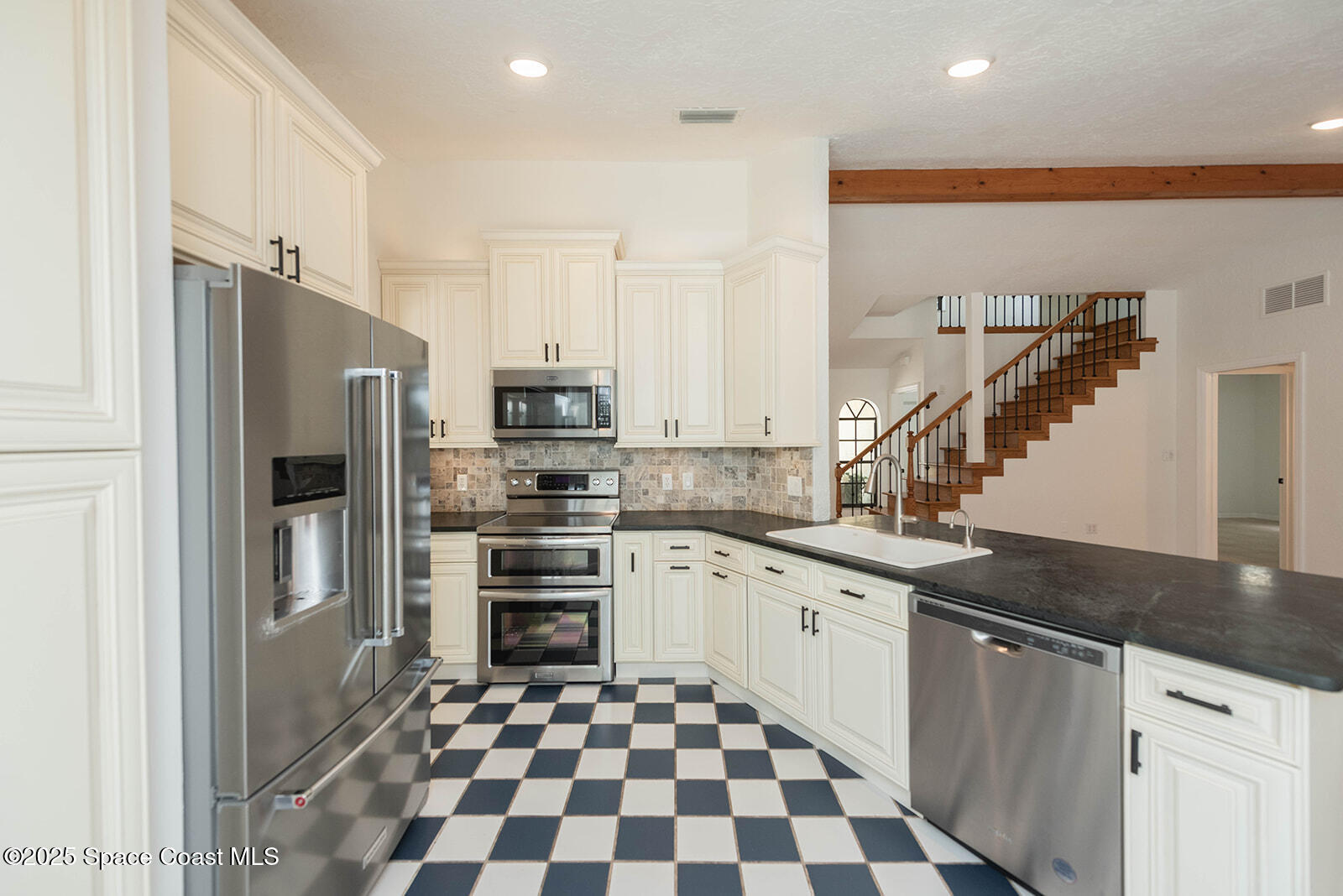 6 Point View Place Cocoa, FL 32926 - Photo 6 of 27 a kitchen with granite countertop stainless steel appliances a sink and counter space