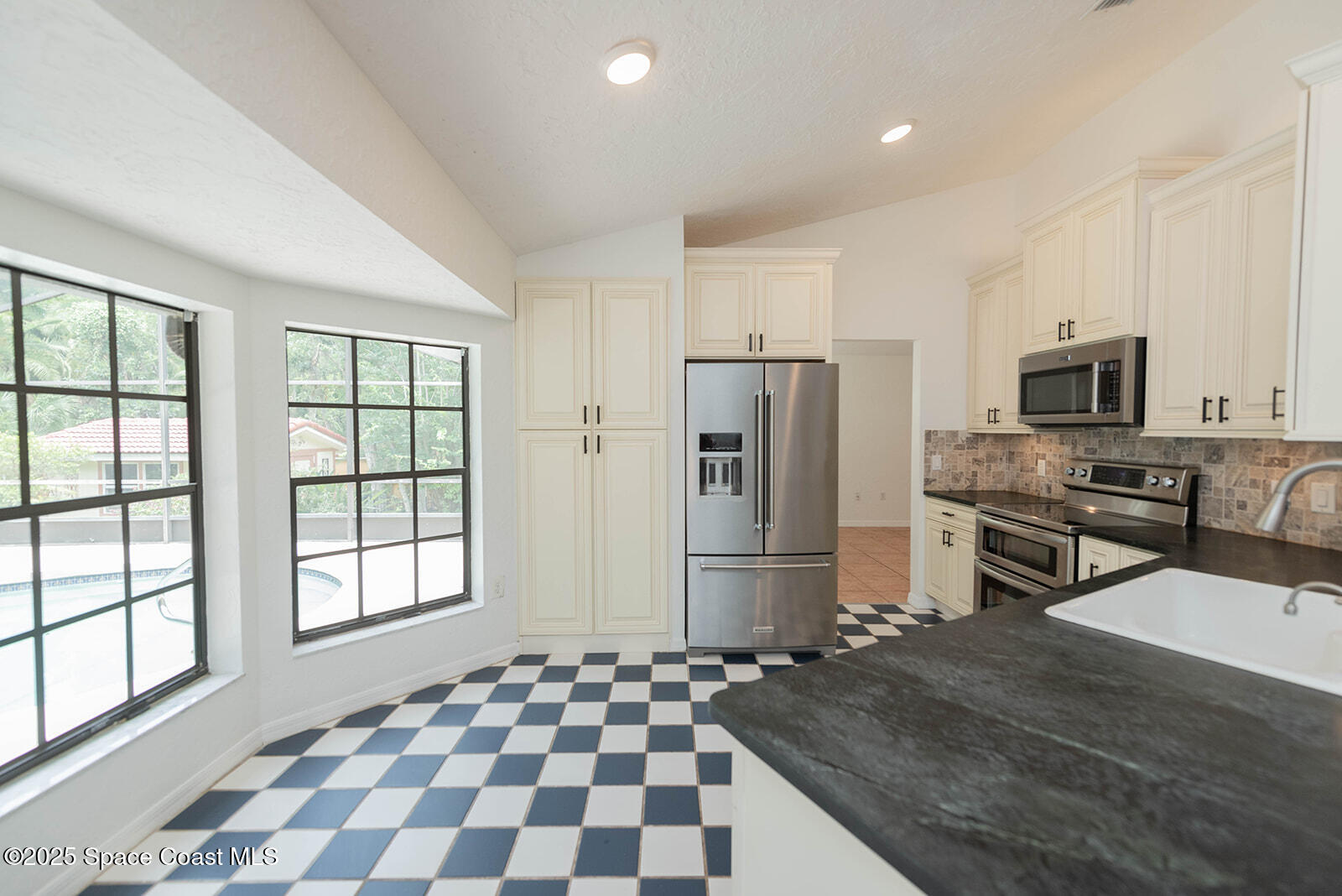 6 Point View Place Cocoa, FL 32926 - Photo 7 of 27 a kitchen with stainless steel appliances granite countertop a refrigerator and a stove top oven