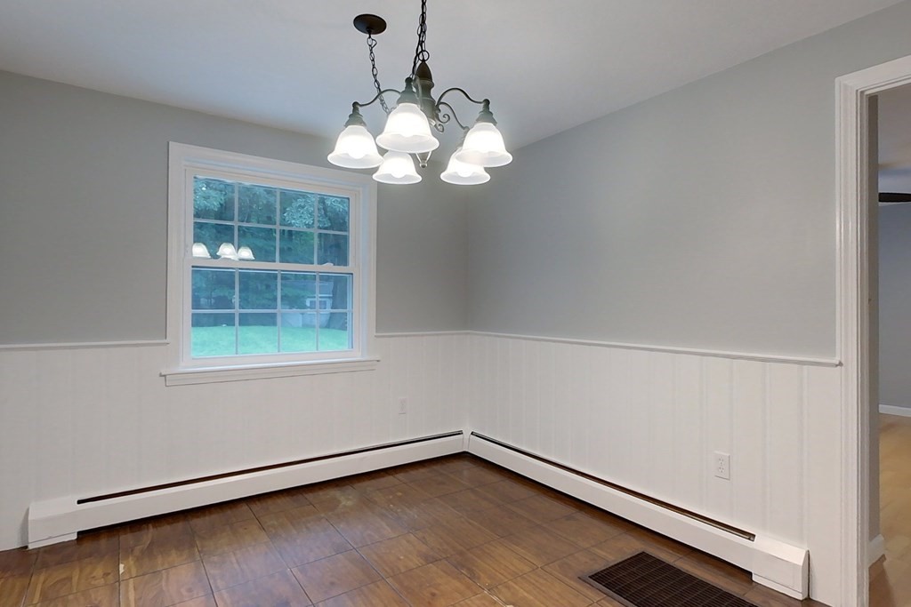 308 Erickson Road Ashby, MA 01431 - Photo 9 of 40 a view of a room with wooden floor and chandelier