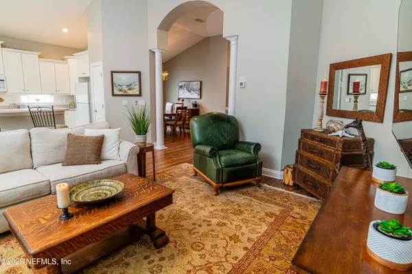 a living room with furniture and wooden floor