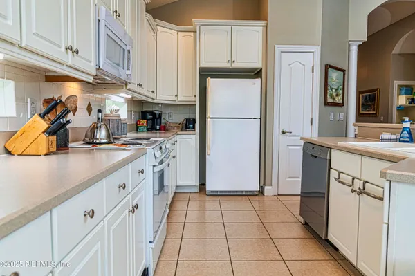 a kitchen with stainless steel appliances granite countertop a refrigerator sink and cabinets