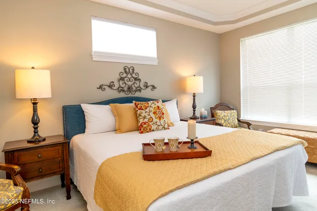 a bedroom with a bed and window