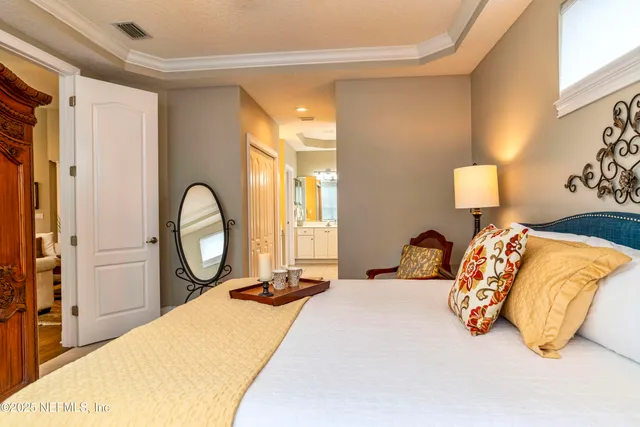 a bedroom with a bed and window