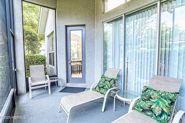 a living room filled with furniture and a potted plant