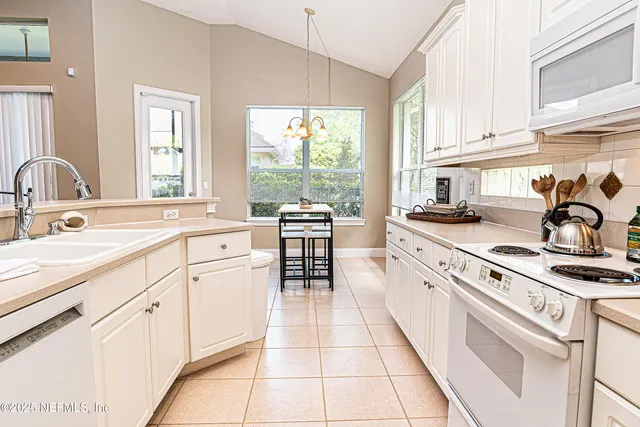 a kitchen with appliances cabinets and a window