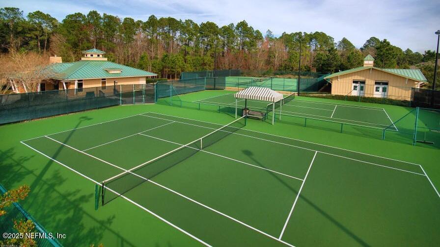 341 Island Green Drive St. Augustine, FL 32092 - Photo 41 of 49 a view of a tennis ground with large trees and a big yard
