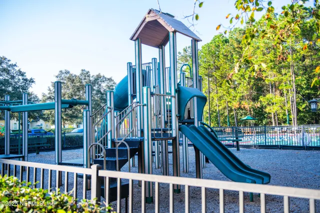 a view of a house with a small yard and wooden fence