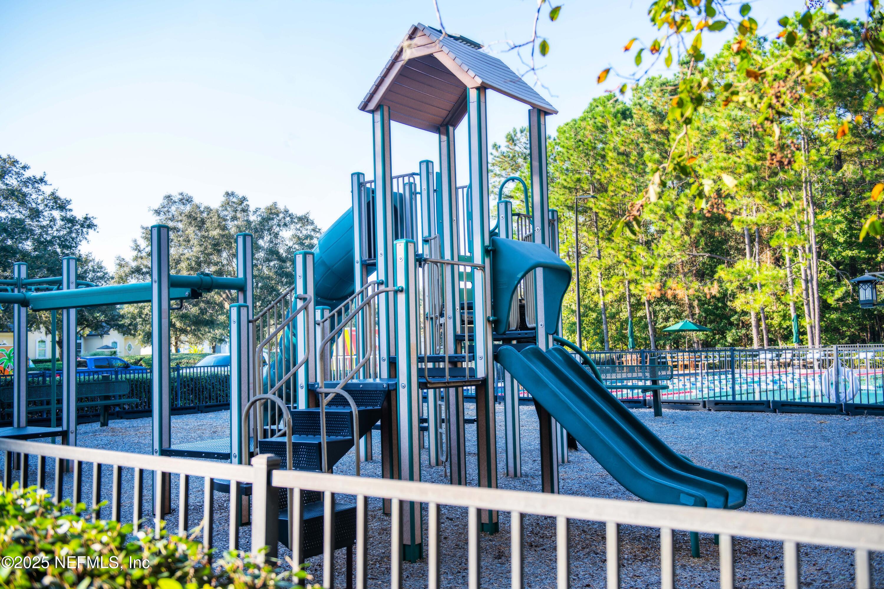 341 Island Green Drive St. Augustine, FL 32092 - Photo 43 of 49 a view of a house with a small yard and wooden fence