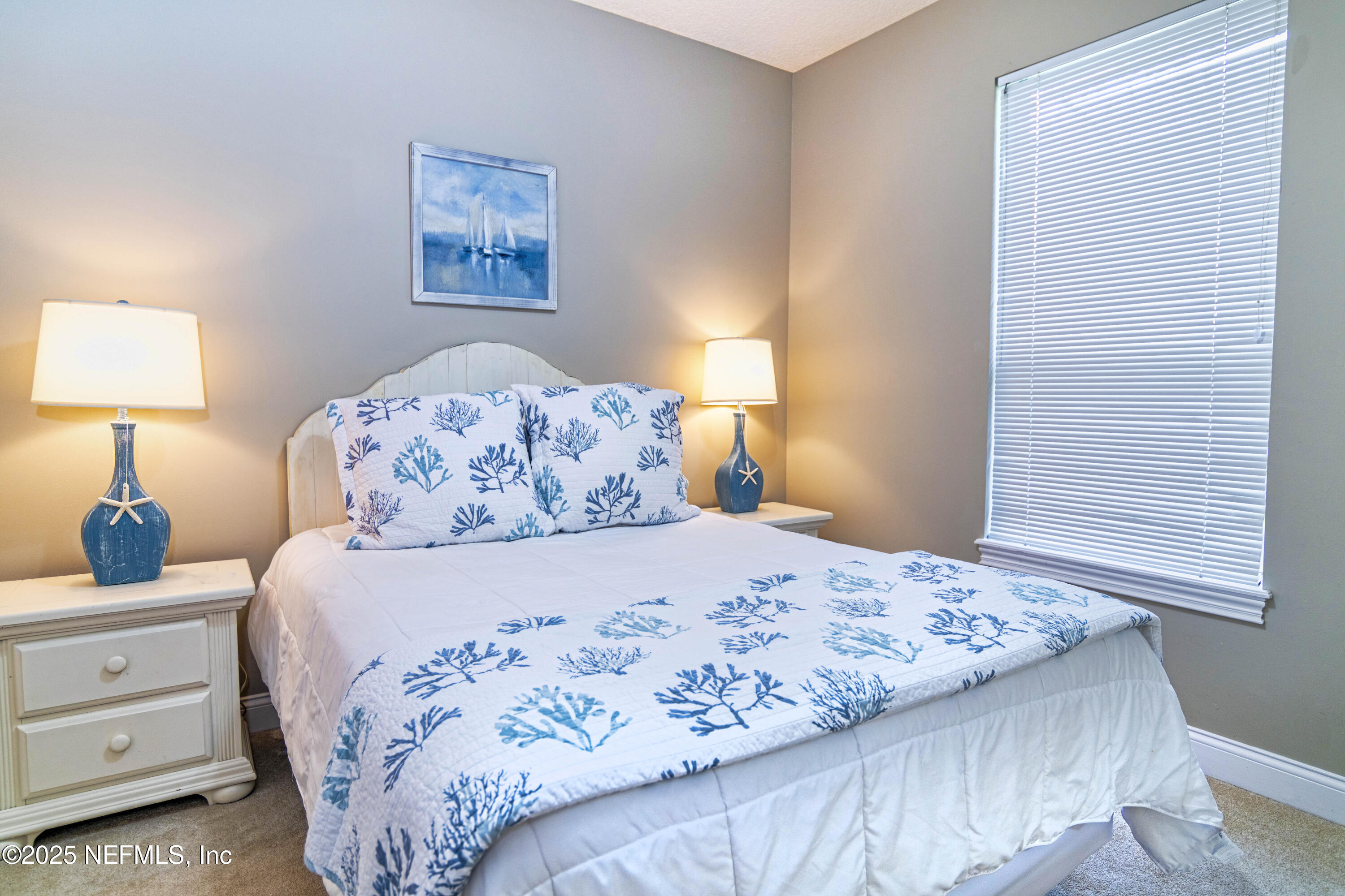 341 Island Green Drive St. Augustine, FL 32092 - Photo 8 of 49 a bedroom with a bed and a lamp on dresser