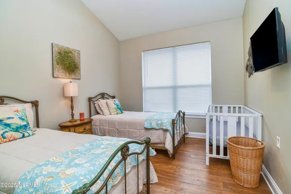 a bedroom with furniture and a flat screen tv