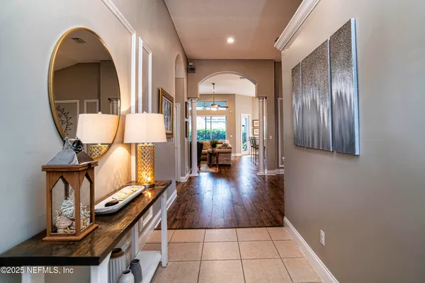 a view of a livingroom with wooden floor and furniture