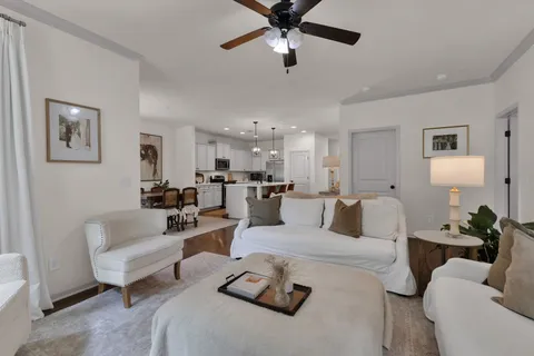 a living room with furniture and a chandelier