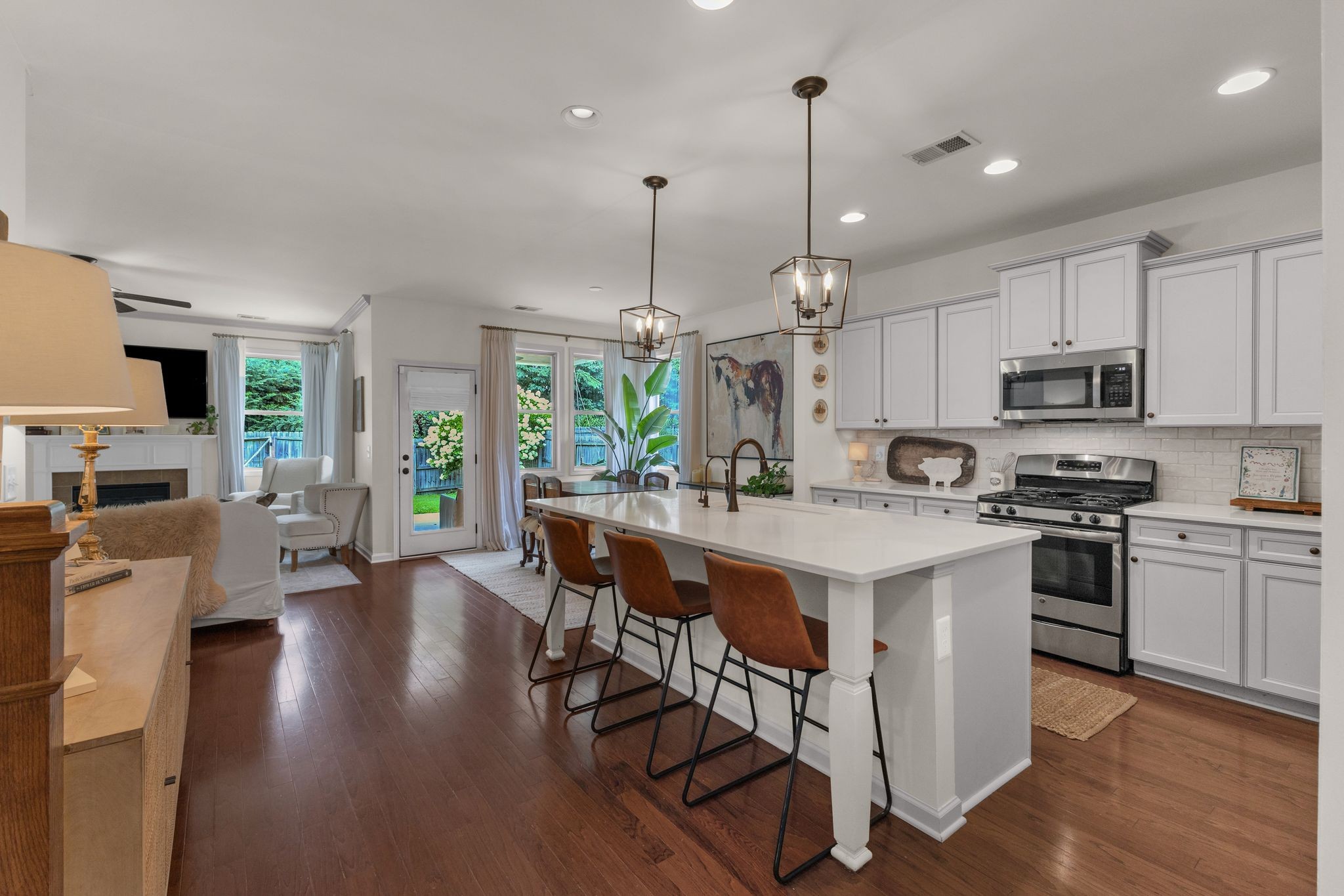 2020 Austin Drive Spring Hill, TN 37174 - Photo 14 of 40 a kitchen with stainless steel appliances kitchen island wooden floors and white cabinets