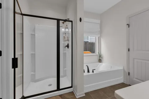 a bathroom with a bathtub and a shower