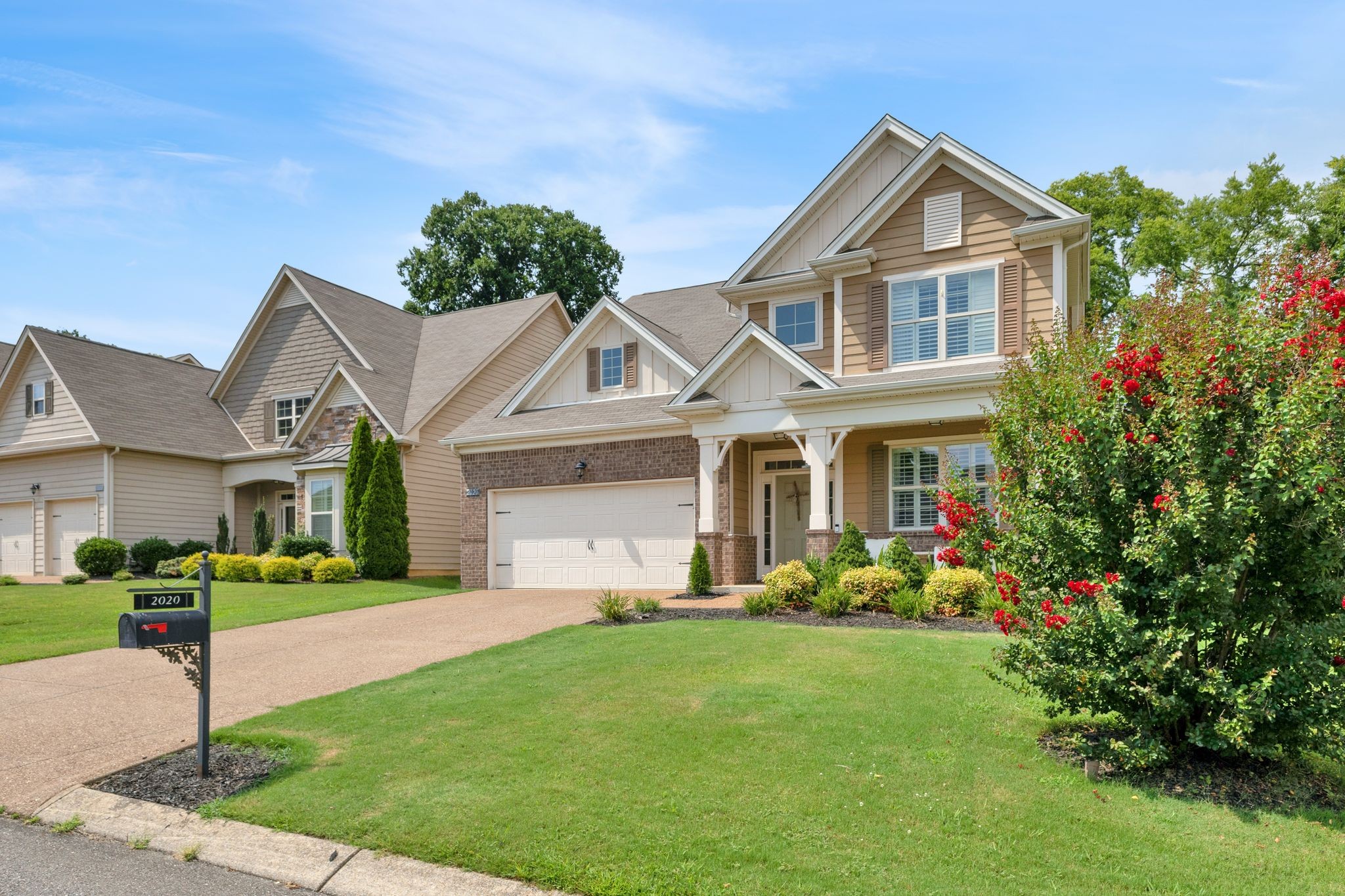2020 Austin Drive Spring Hill, TN 37174 - Photo 3 of 40 a front view of a house with a garden and trees