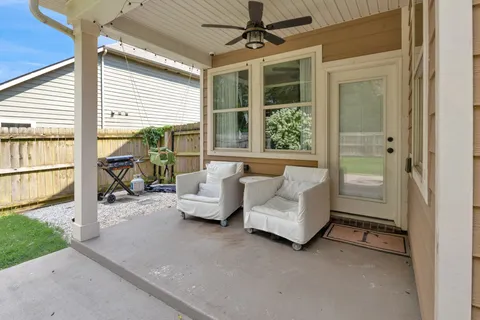a balcony with furniture and a window