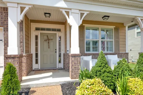 a front view of a house with a garden