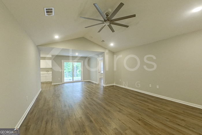 132 Cottage Grove Road Brunswick, GA 31525 - Photo 4 of 17 an empty room with wooden floor and windows