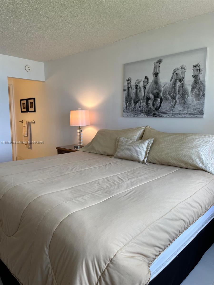 4200 North Hwy A1A, Unit 614 Fort Pierce, FL 34949 - Photo 12 of 63 a bedroom with a bed and wall painting