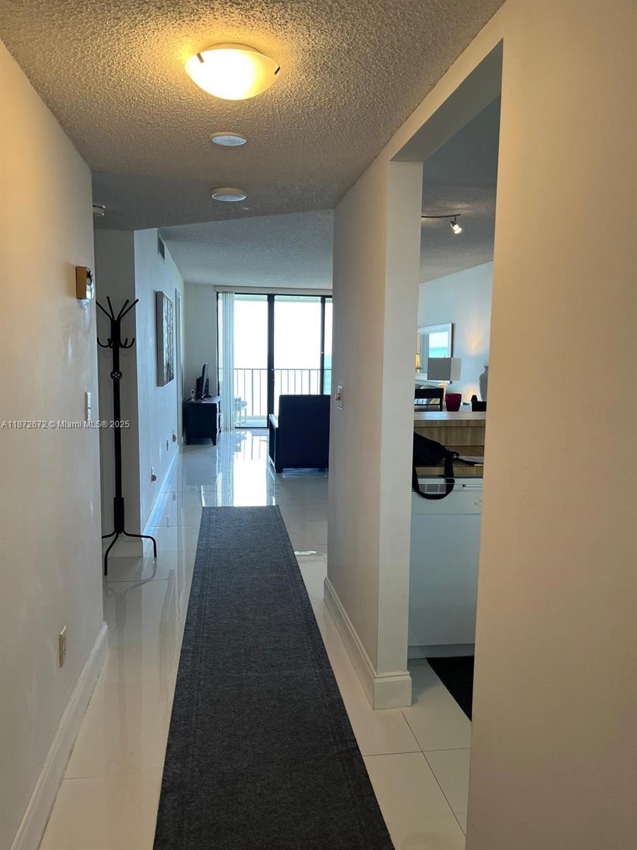 4200 North Hwy A1A, Unit 614 Fort Pierce, FL 34949 - Photo 14 of 63 a view of a hallway with a couch and a fireplace