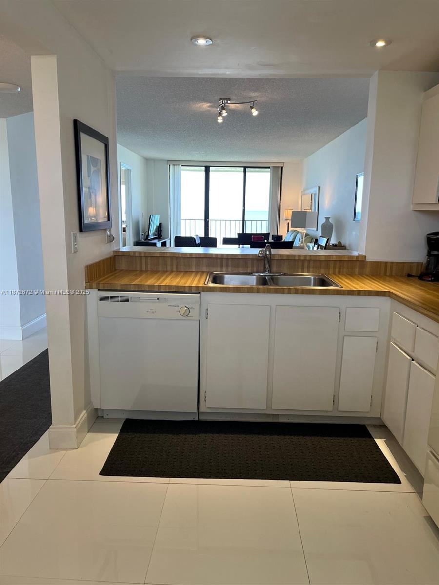 4200 North Hwy A1A, Unit 614 Fort Pierce, FL 34949 - Photo 16 of 63 a large kitchen with granite countertop a stove and a sink