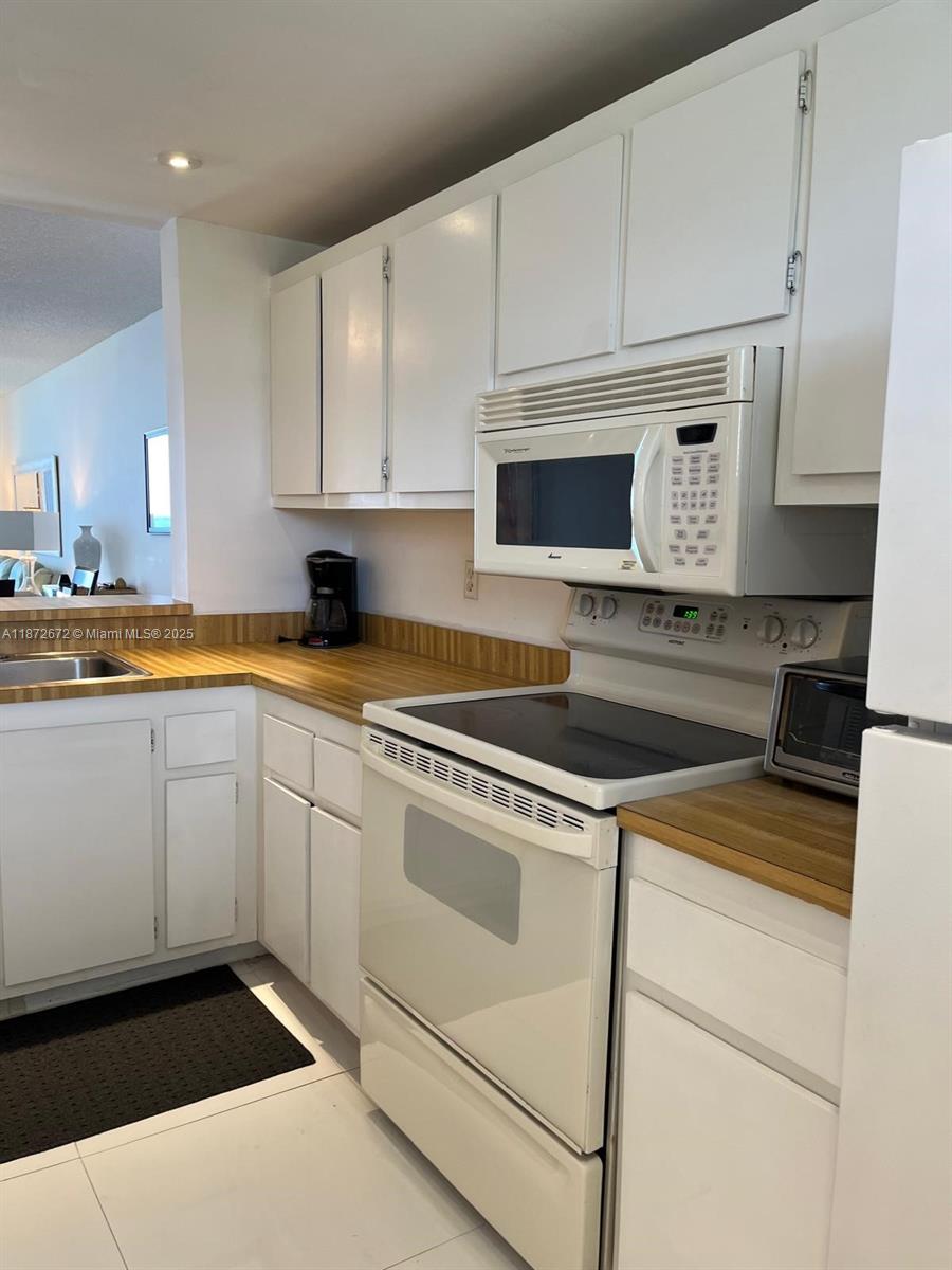 4200 North Hwy A1A, Unit 614 Fort Pierce, FL 34949 - Photo 17 of 63 a kitchen with a sink stove and cabinets
