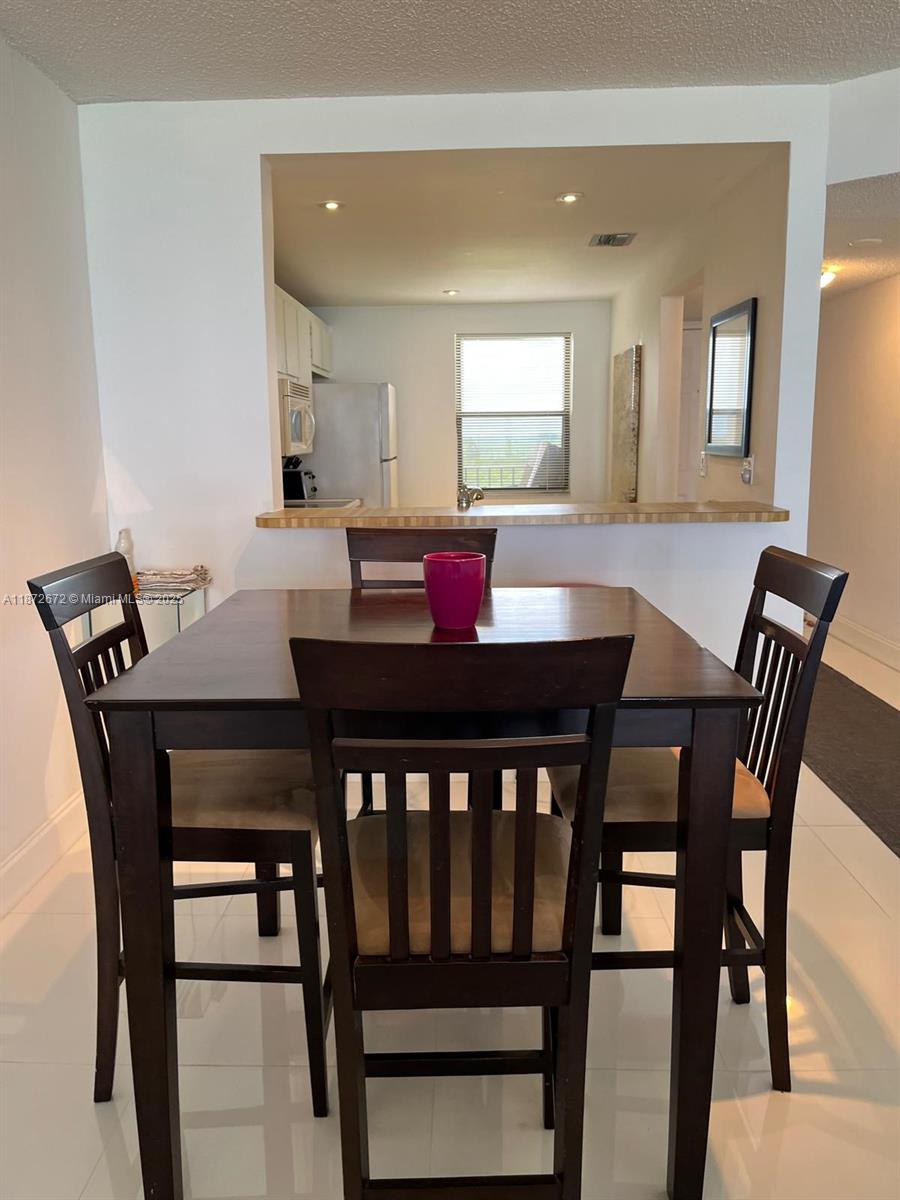 4200 North Hwy A1A, Unit 614 Fort Pierce, FL 34949 - Photo 20 of 63 a view of a dining room with furniture and wooden floor
