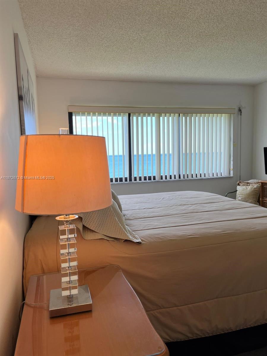 4200 North Hwy A1A, Unit 614 Fort Pierce, FL 34949 - Photo 22 of 63 a bed sitting in a bedroom next to a window