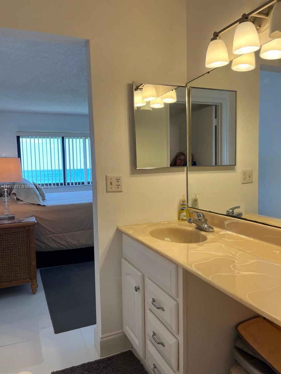 4200 North Hwy A1A, Unit 614 Fort Pierce, FL 34949 - Photo 26 of 63 a en suite bathroom with a sink and a mirror