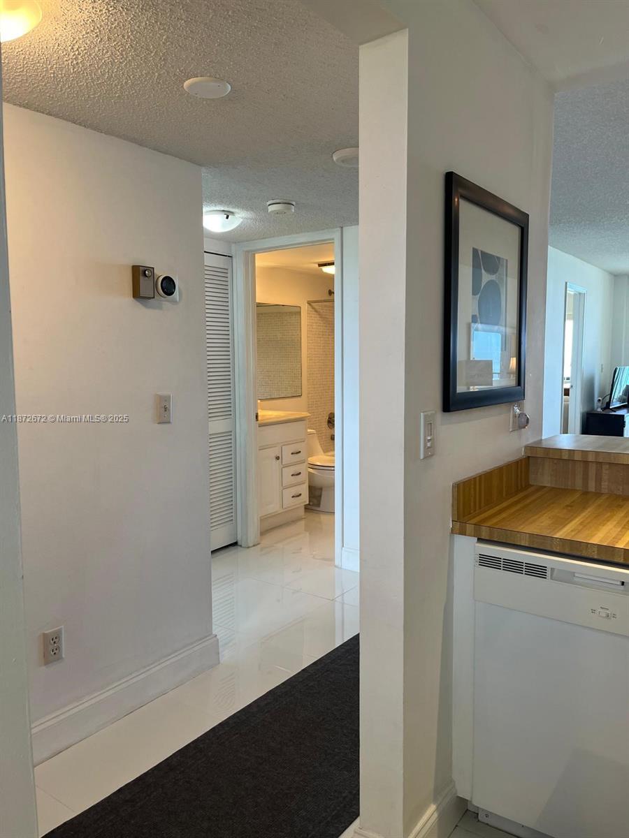 4200 North Hwy A1A, Unit 614 Fort Pierce, FL 34949 - Photo 27 of 63 a bathroom with a granite countertop sink mirror and shower