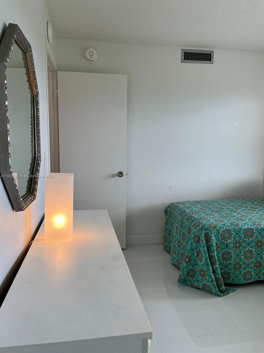 4200 North Hwy A1A, Unit 614 Fort Pierce, FL 34949 - Photo 30 of 63 a en suite bathroom with a sink and mirror