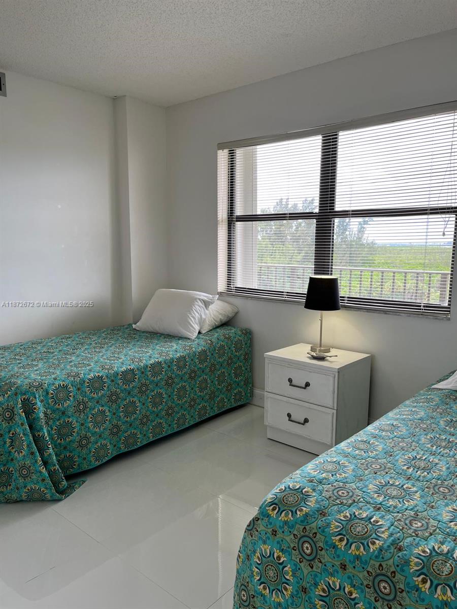 4200 North Hwy A1A, Unit 614 Fort Pierce, FL 34949 - Photo 31 of 63 a bedroom with a bed and a window