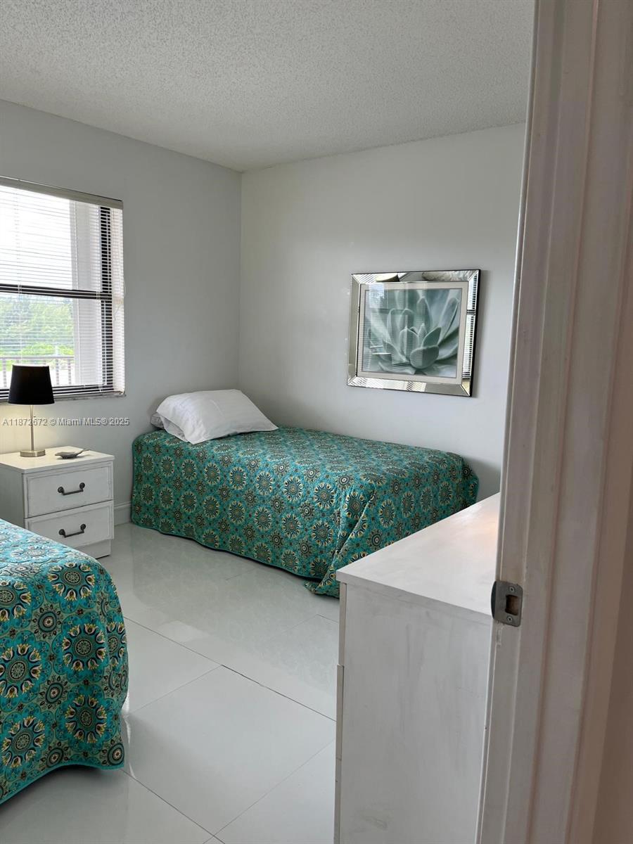 4200 North Hwy A1A, Unit 614 Fort Pierce, FL 34949 - Photo 33 of 63 a bedroom with a bed and a window