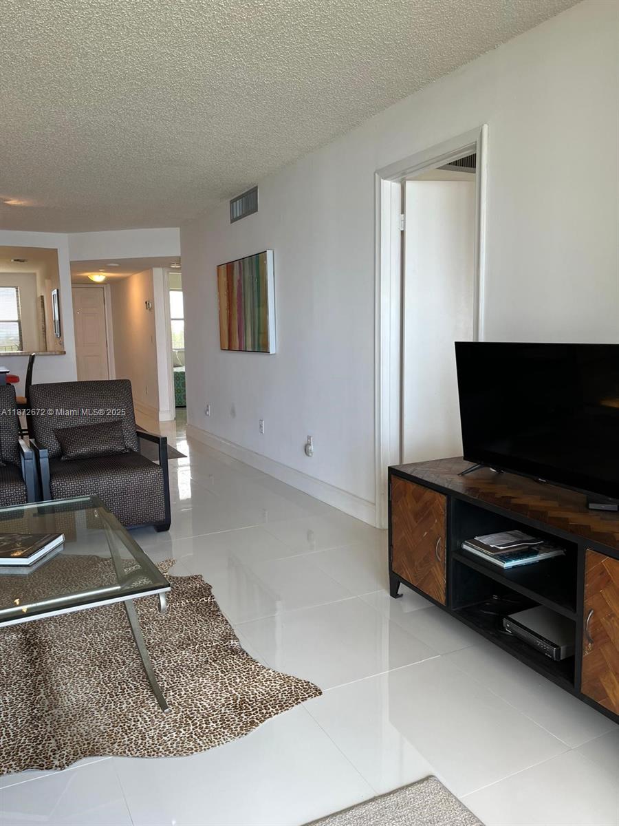 4200 North Hwy A1A, Unit 614 Fort Pierce, FL 34949 - Photo 49 of 63 a living room with furniture and a flat screen tv