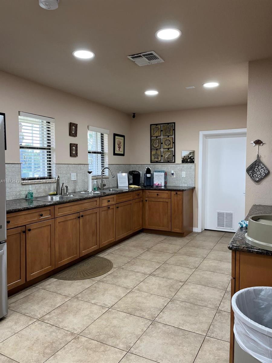 4200 North Hwy A1A, Unit 614 Fort Pierce, FL 34949 - Photo 57 of 63 a large kitchen with kitchen island granite countertop a sink and a stove top oven