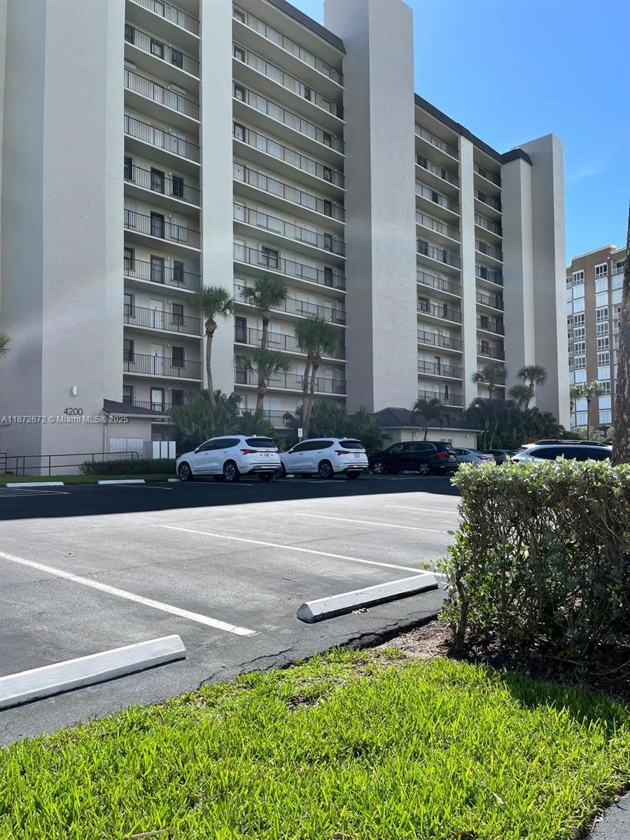 4200 North Hwy A1A, Unit 614 Fort Pierce, FL 34949 - Photo 59 of 63 a front view of a building with a yard and plants