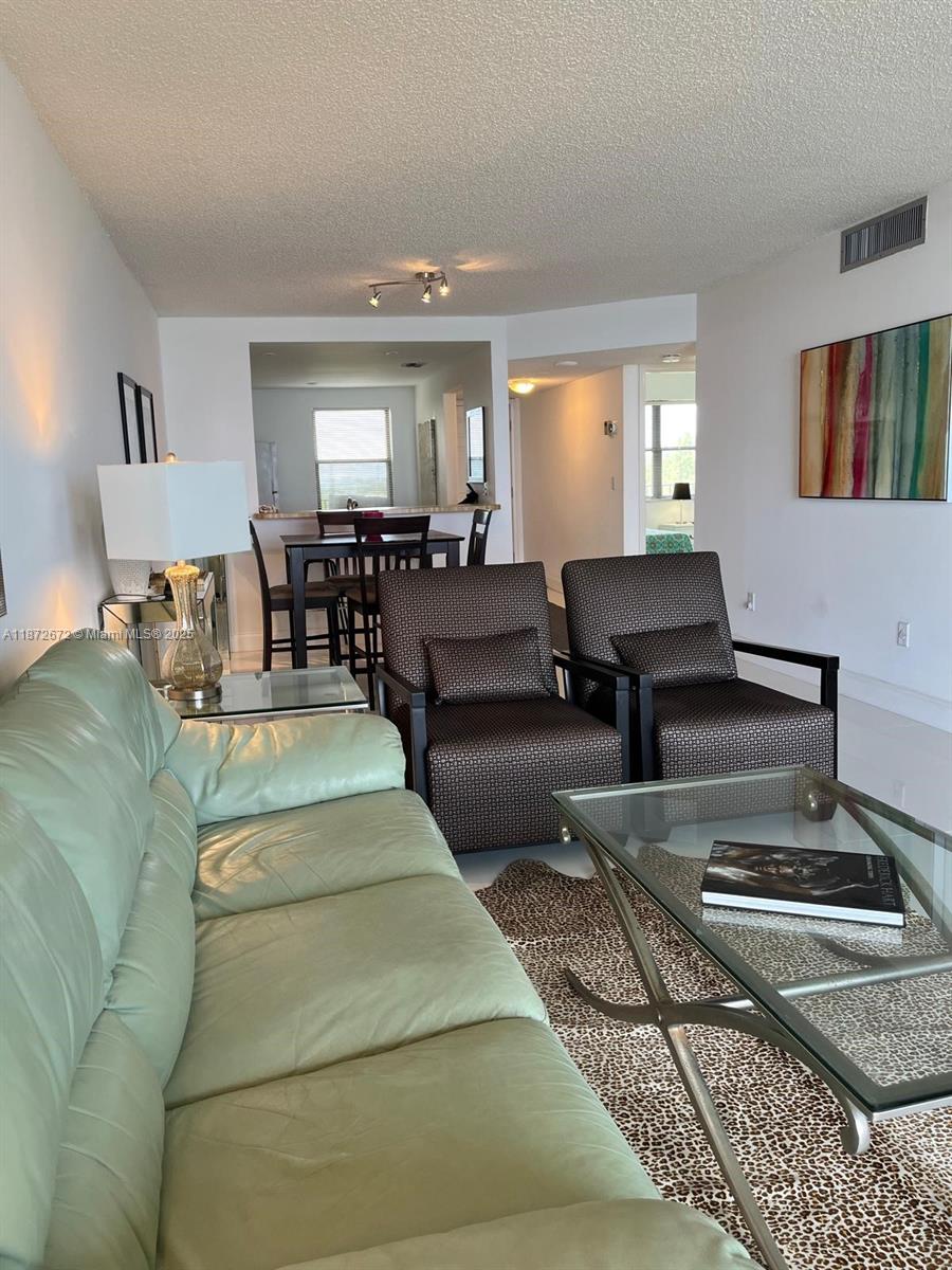 4200 North Hwy A1A, Unit 614 Fort Pierce, FL 34949 - Photo 7 of 63 a living room with furniture and a rug