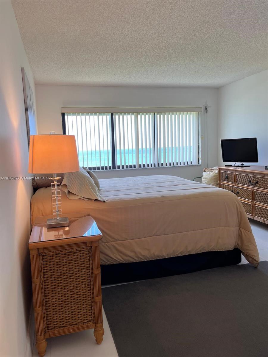 4200 North Hwy A1A, Unit 614 Fort Pierce, FL 34949 - Photo 9 of 63 a bedroom with a bed and window