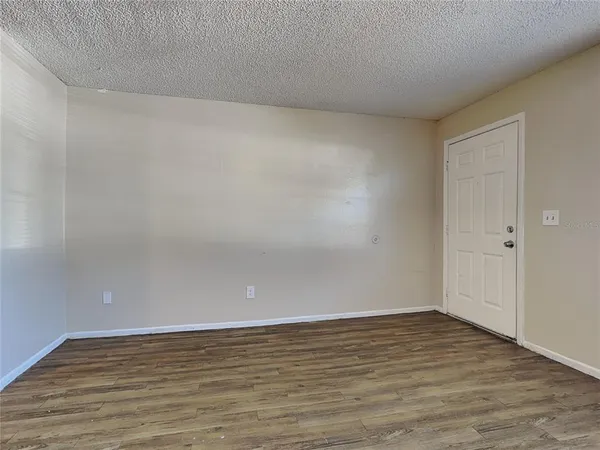 a view of an empty room and wooden floor