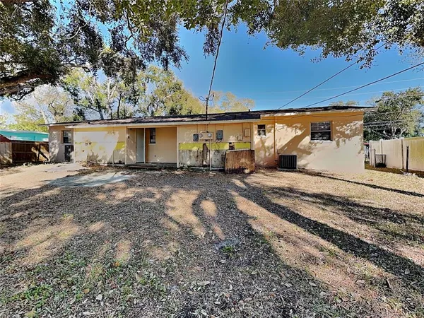 a backyard of a house with table and chairs