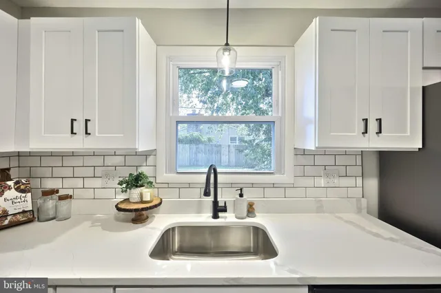 a bathroom with a sink and a window