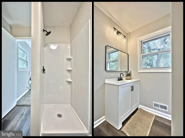 a bathroom with a tub sink and mirror