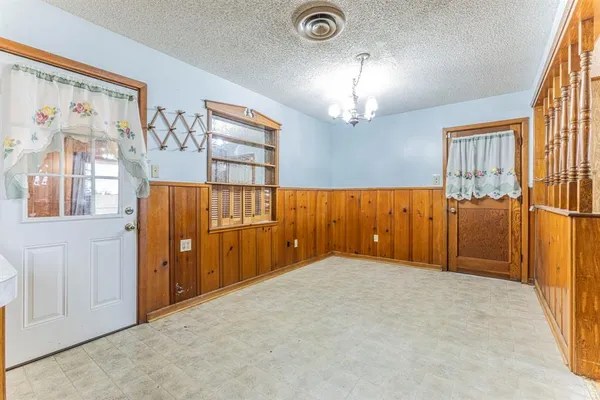 a kitchen with stainless steel appliances kitchen island granite countertop a refrigerator and cabinets