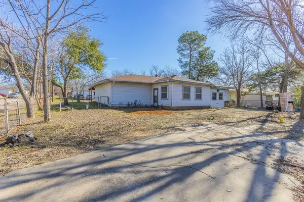 a view of a house with a yard and pathway