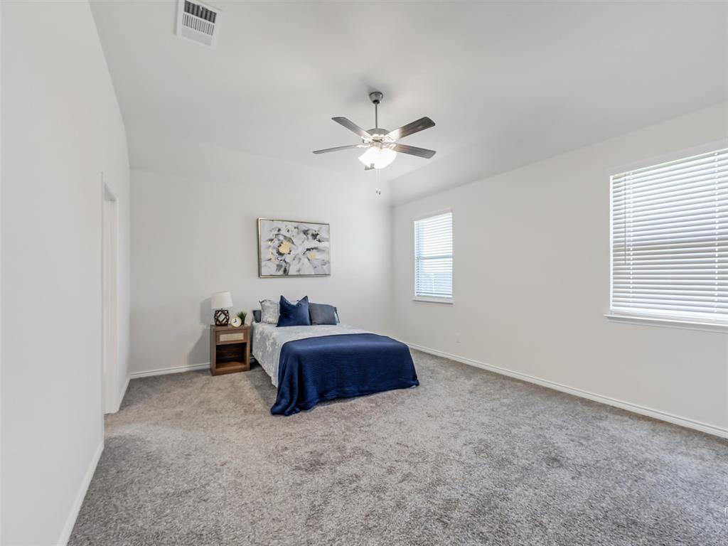 3024 Meredith Lane Forney, TX 75126 - Photo 11 of 29 Bedroom featuring plush gray carpeting, white walls, and a ceiling fan with integrated lighting