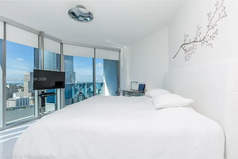 a bedroom with a bed and a mirror