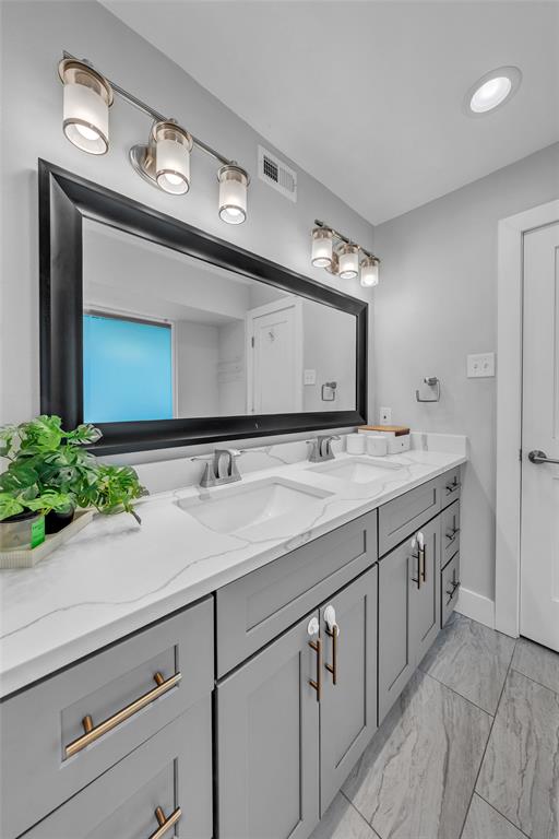 3837 Kimball Ridge Drive Dallas, TX 75233 - Photo 29 of 40 a bathroom with a sink and a mirror
