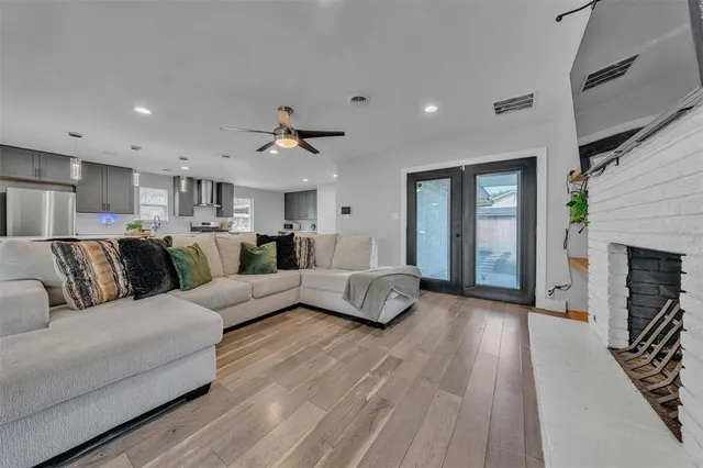 a living room with furniture and a potted plant