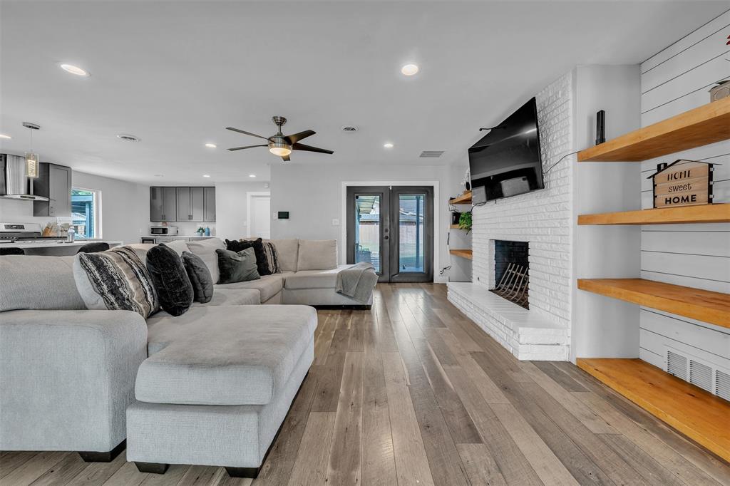 3837 Kimball Ridge Drive Dallas, TX 75233 - Photo 37 of 40 a living room with furniture a fireplace and a flat screen tv