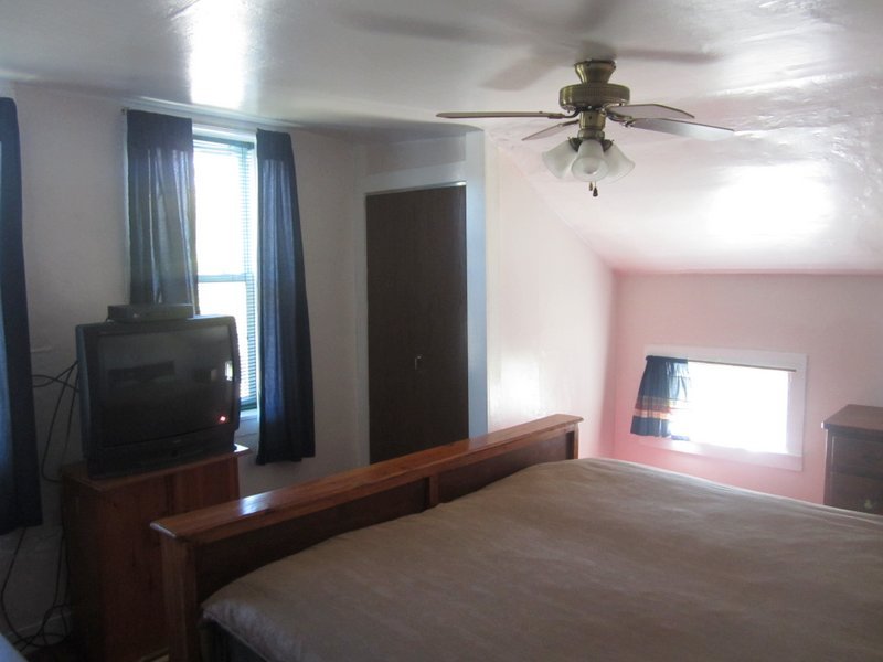 102 South Main Road Otis, MA 01253 - Photo 11 of 25 a bedroom with a bed and a chandelier fan